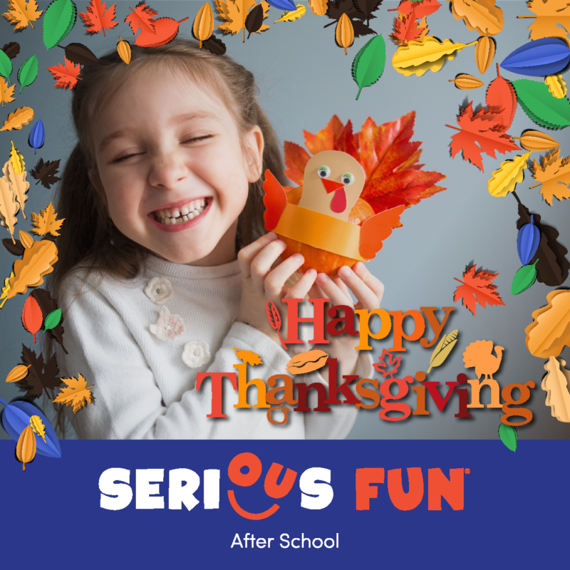 Little kid holding up leaf made Turkey with the saying happy Thanksgiving